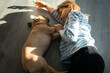 Girl teenager laying on the floor with french bulldog puppy, home cozy life