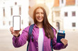 Millennial woman tourist with smartphone and passport