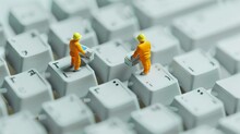 Miniature Illustration Of Two Tiny Programmers Vacuuming The Dust From Realistic Laptop Keyboard Keys