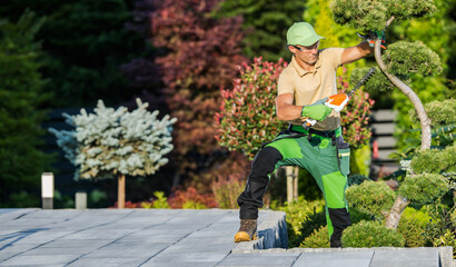 Wall Mural - Gardener Trimming and Shaping Decorative Plants