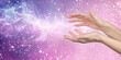 Sending you the highest vibrational love healing frequency energy - female parallel hands sending out high vibes against a pink purple background with copy space
