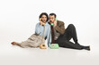 © master1305 - Emotional young man and woman sitting on floor and talking on vintage rotary phone isolated on white background. Communication, news. Concept of retro and vintage, fashion, human emotions, style