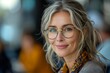 © Larisa AI - A portrait of a smiling woman with grey hair wearing glasses and a scarf, conveying confidence and approachability