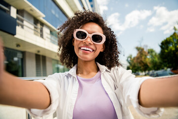 Sticker - Photo of cheerful positive adorable girl dressed stylish clothes walking spending vacation in big town cityscape downtown outside