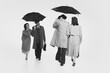 © master1305 - Two couple in elegant cloches, trench coats walking under umbrella. Monochrome image. Couple greeting. Concept of retro and vintage, fashion, relationship, friendship, communication