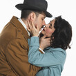 © master1305 - Portrait of happy young couple, man and woman in retro-styled clothes, coats standing and kissing. Tenderness and passion. Concept of retro and vintage, fashion, romance, relationship