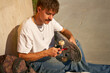 View of a man repairing his skateboard in the skate park. Extreme sport concept