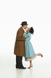 © master1305 - Portrait of happy young couple, man and woman in retro-styled clothes, coats standing and kissing. Valentine's Day. Concept of retro and vintage, fashion, romance, relationship
