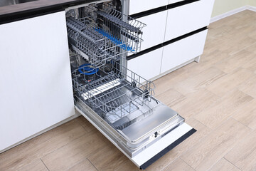 Sticker - Open clean empty dishwasher in kitchen. Home appliance