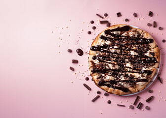 Wall Mural - whole Brazilian chocolate Pizza on pink Background with copy space