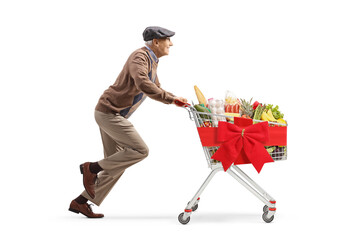 Poster - Full length profile shot of a pensioner running with food in a shopping cart