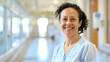 © Generative AI - Portrait of smiling biracial female healthcare worker in hospital corridor copy space Hospital medical and healthcare services : Generative AI
