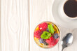 Healthy vanilla chia pudding in a glass with fresh berries and coffee