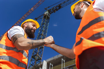 contractor. construction worker team hands shaking after plan project contract at construction site,