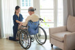 © chokniti - asian woman doctor nursing home to helping take care to retirement patient who sitting on wheelchair, caregiver nurse support to medical health care insurance at home or hospital, elderly senior man