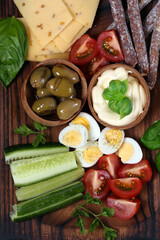 Poster - antipasti tapas with cheese and ham on wooden table