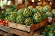 Artichokes attractively arranged in a wooden crate at a market, showcasing their fresh, edible buds