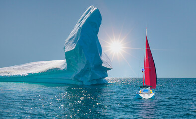 Wall Mural - Giant iceberg near Kulusuk with lone yacht with red sails - Greenland, East Greenland