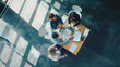 © Generative AI - Top view of group of multiethnic busy people working in an office Aerial view with businessman and businesswoman sitting around a conference table with blank copy space Business meetin : Generative AI