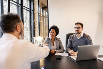 Successful partnership. Interracial businesspeople shaking hands after job interview.