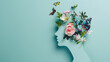 Cardboard silhouette of human head decorated with flowers and butterfly on mint background World mental health day concept Vertical banner Copy space : Generative AI