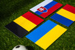 Group E at Europe football tournament in Germany in 2024. Flags of Belgium, Slovakia, Romania, Ukraine and soccer ball on green grass