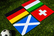 Group A at Europe football tournament in Germany in 2024. Flags of Germany, Scotland, Hungary, Switzerland and soccer ball on green grass