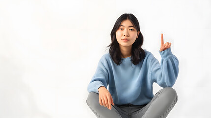 Aufkleber - Young Asian woman sitting and pointing to empty copy space isolated on white background Full body composition : Generative AI