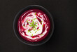 Beetroot soup isolated on black background, top view