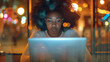 Young African American woman working with laptop at a cafe. Through the showcase, an African American woman radiates professionalism in the moonlight.