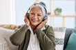 © peopleimages.com - Portrait, house and old woman with headphones, streaming music or retirement with audio or listening to radio. Face, senior person or relax with pensioner or headset with podcast, smile or sound