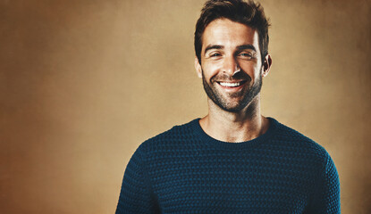 Aufkleber - Smile, portrait and man with clothes for fashion, style and casual wear isolated on brown background. Face, happy or model with trendy sweater, closeup and cool person in studio backdrop with mockup