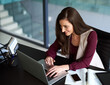 © peopleimages.com - Business, laptop and woman in office and working, answer email or browsing online with social media. Connection, internet networking and communication, technology with company application for job