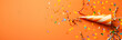 Party popper web banner. Colorful party popper isolated on orange background with copy space.