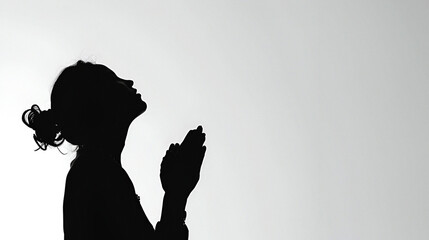 Silhouette of a women praying with copy space