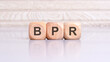 concept of BPR word on wooden cubes, wooden background