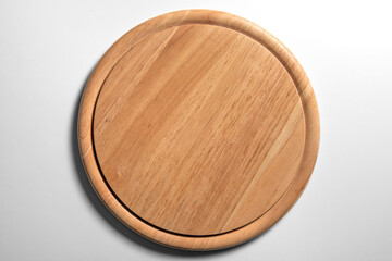 Isolated empty round wooden chopping board