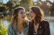 © olegganko - Two Young Women Laughing and Looking at Each Other
