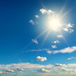 Bright sun on blue sky with beautiful clouds