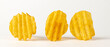 © Roman - Three wavy chips on a white background with a cropped outline. Corrugated potato chips.