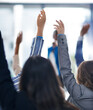 © peopleimages.com - Meeting, workshop and hands of business people for questions, asking or crowd interaction. Hey, attention or audience with tradeshow faq, volunteer or event participation for training presentation