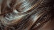 A close up of a woman's hair with some strands sticking out, AI