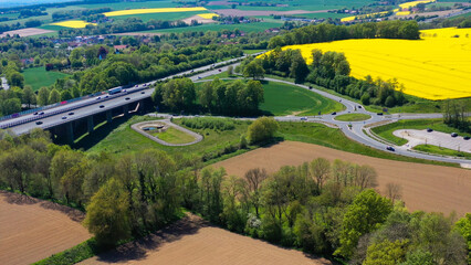 Aerial drone view of yellow rapeseed fields in German countryside