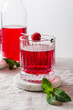 Raspberry drink in a glass on a marble stand