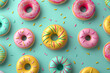 assorted frosted donuts arranged in a pattern on a mint green background