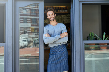 Poster - Smile, small business and portrait of man with arms crossed at coffee shop for service industry, welcome or working. Happy, entrepreneur and barista with apron at cafe entrance, doorway or front door