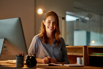 Canvas Print - Woman, employee and smile in office with computer on work break for overtime or deadline at night. Female person, portrait and worker with notepad as administrator for schedule, agenda and notes