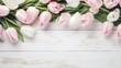 Pink tulips on white wooden background. Blooming flowes spring background banner - Peach fuzz pink tulips, on white shabby wooden table, top view