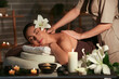© Pixel-Shot - Young woman getting massage in dark spa salon, closeup