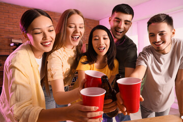 Wall Mural - Group of young friends drinking beer at party